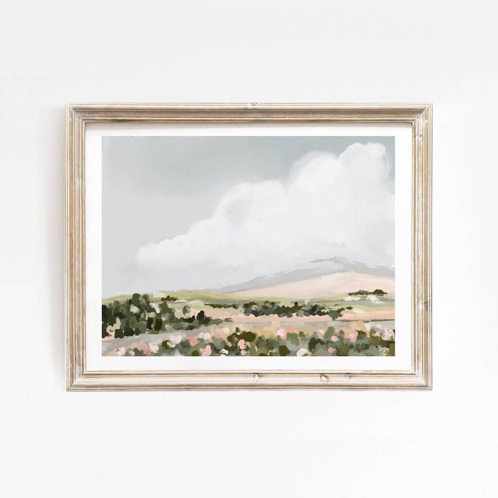 Colourful pastel toned landscape print of a blue sky with swirly white clouds, green trees, and pink and white florals.